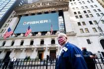 Stock trader Thomas Ferrigno arrives to work at the New York Stock Exchange, Monday, Nov. 9, 20 ...