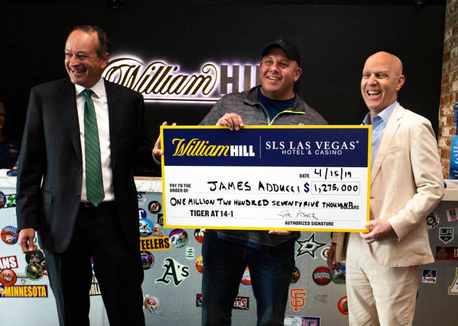 William Hill CEO Joe Asher, stands with big winner James Adducci of Wisconsin and SLS General M ...