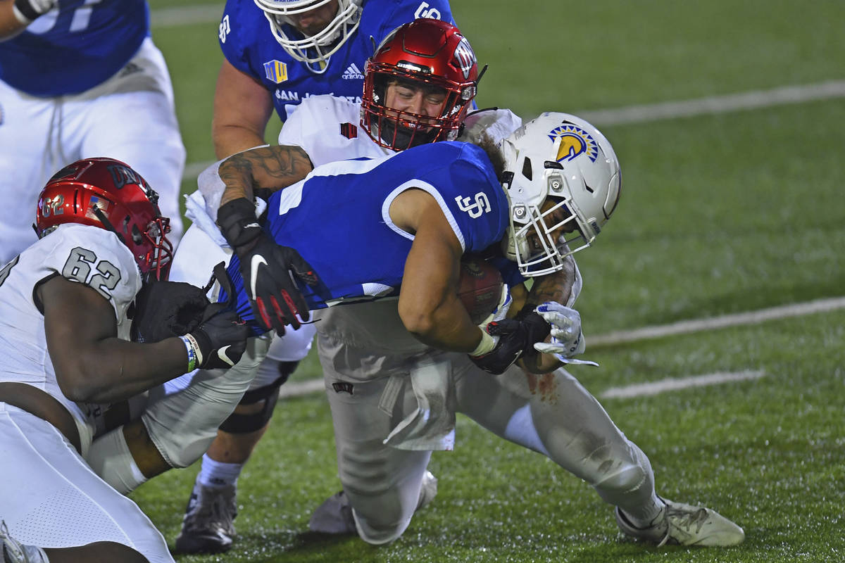 San Jose State's Kairee Robinson (32) is tackled by UNLV's Vic Viramontes (10) during the first ...