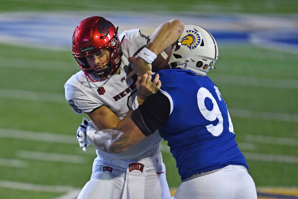 San Jose State's Cade Hall (92) tackles UNLV quarterback Max Gilliam, left, during the first qu ...