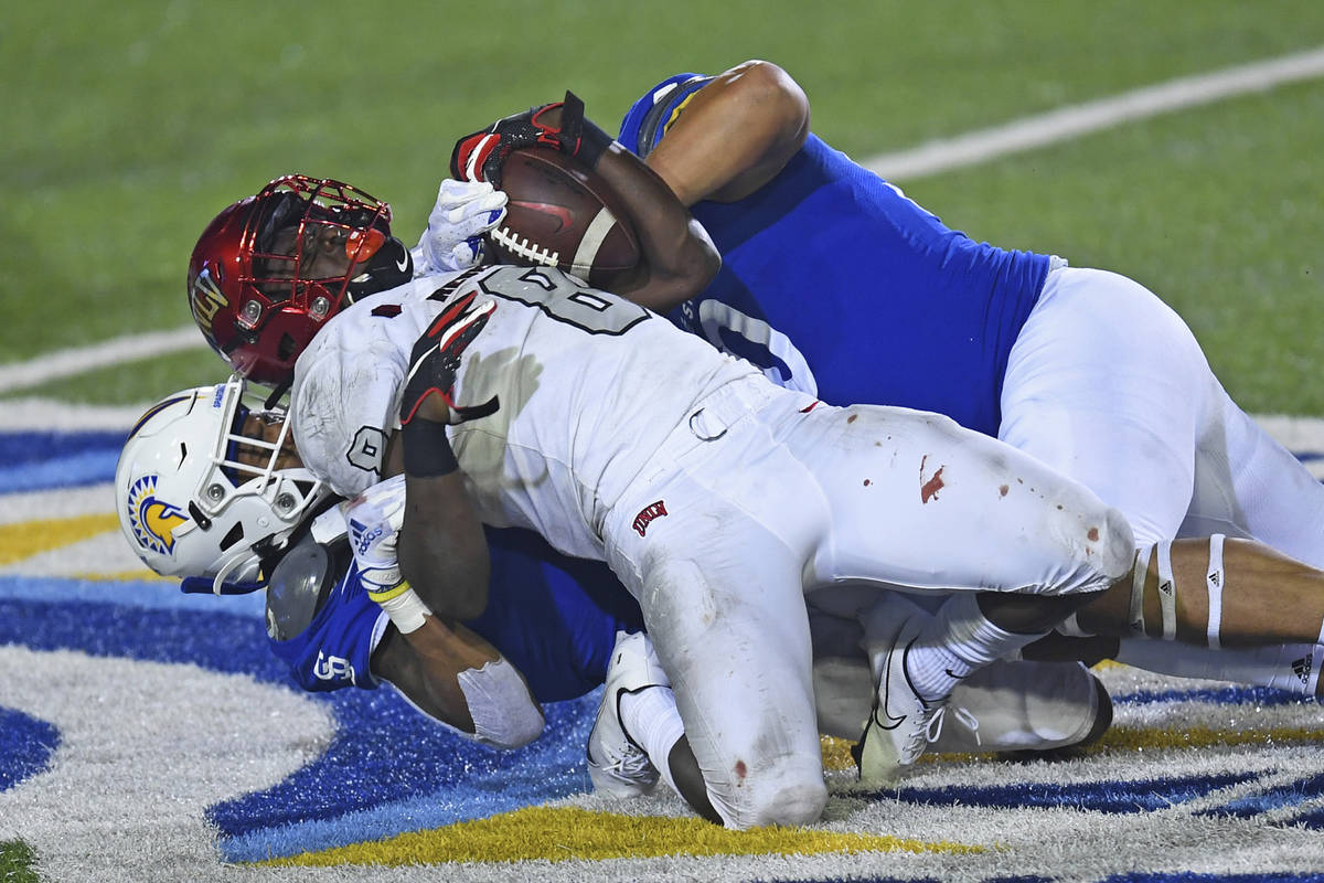 San Jose State's Tre Webb (3) and Lando Grey (90) tackle UNLV's Charles Williams (8) during the ...
