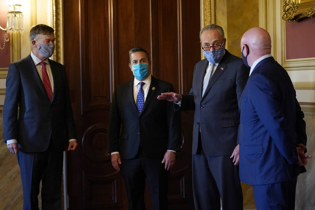 Senate Minority Leader Sen. Chuck Schumer of N.Y., second from right, talks with the newly elec ...