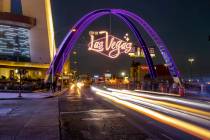 Cars stream down Las Vegas Boulevard as the downtown gateway arches are fully illuminated for t ...