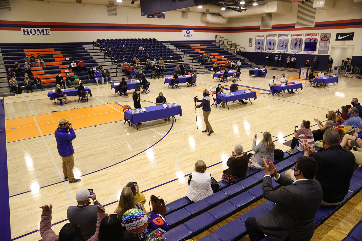 Students and their families participate during a Signing Day ceremony at Bishop Gorman High Sch ...