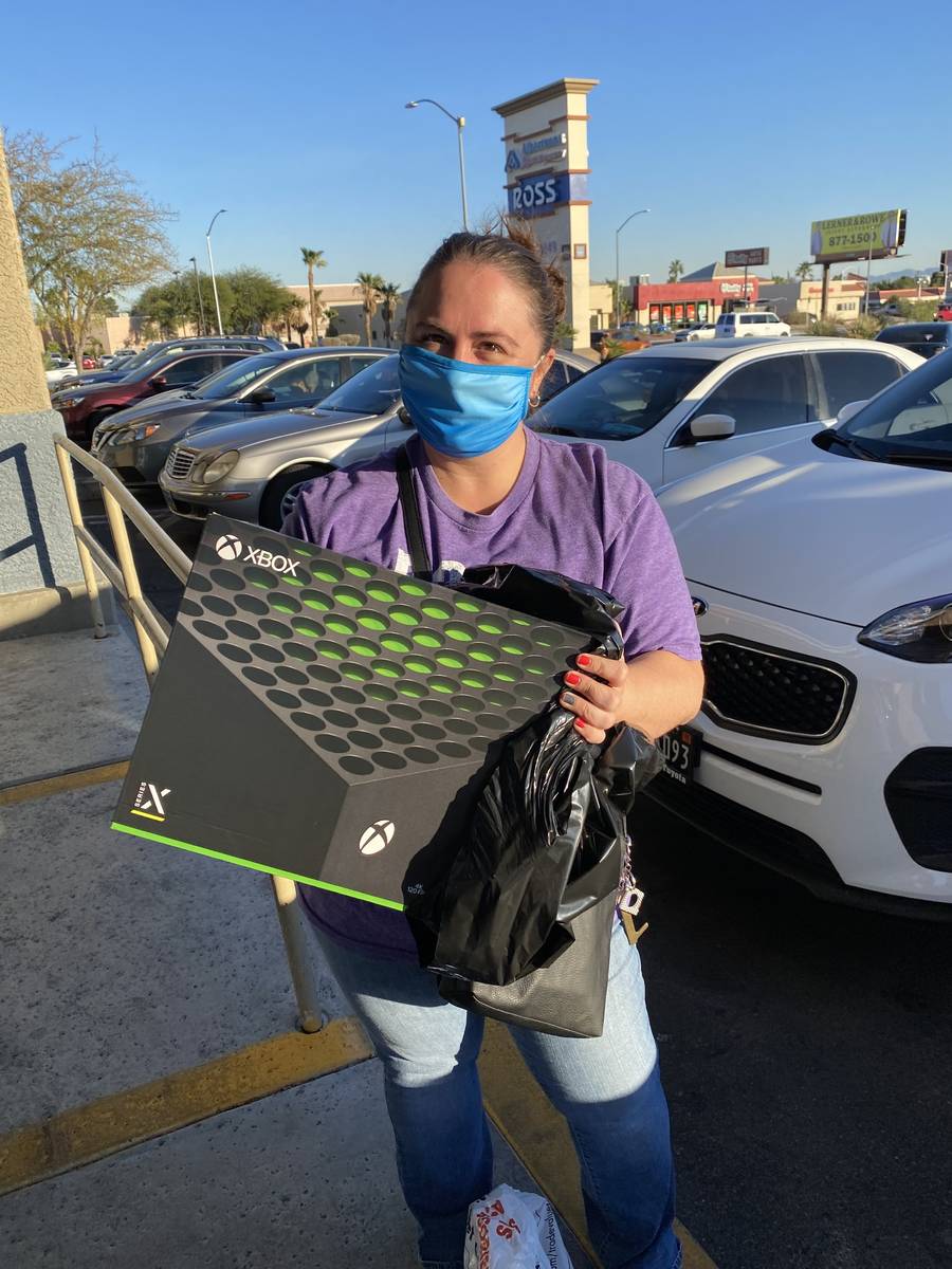 A customer named Holly picks up an Xbox Series X her husband had preordered at Gamestop's Rainb ...