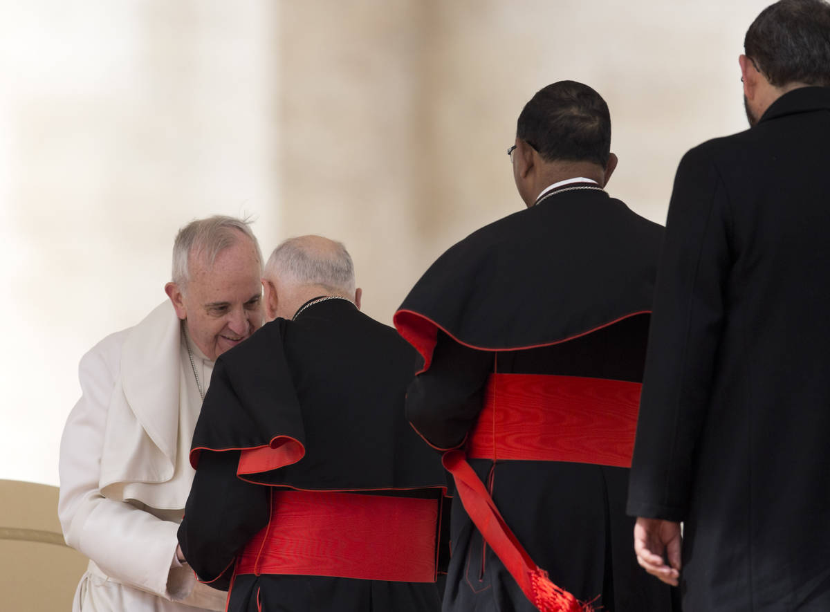 FILE - In this Feb. 19, 2014 file photo, Pope Francis greets U.S. Cardinal Theodore Edgar McCar ...