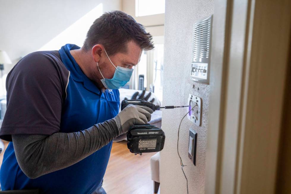ADT Custom Home Services installation manager Chase Errett installs a security system in a home ...