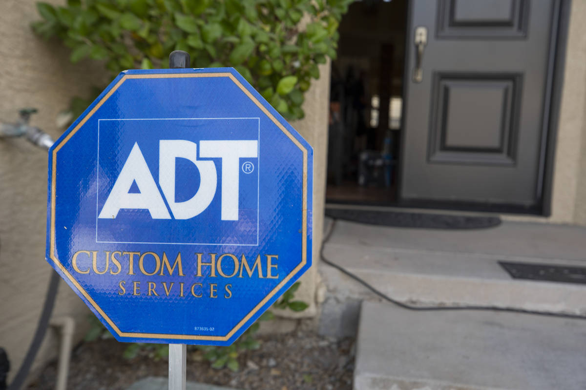 A sign advertising ADT Custom Home Services is seen during an installation of a security system ...