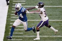 Indianapolis Colts wide receiver Zach Pascal (14) stiff arms Baltimore Ravens defensive back Te ...