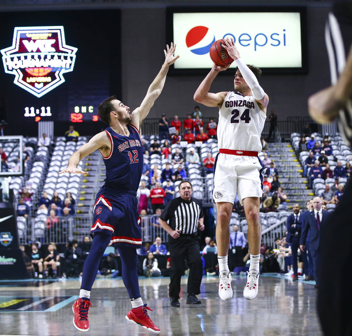 Gonzaga Bulldogs' Corey Kispert (24) shoots over St. Mary's Gaels' Tommy Kuhse (12) during the ...