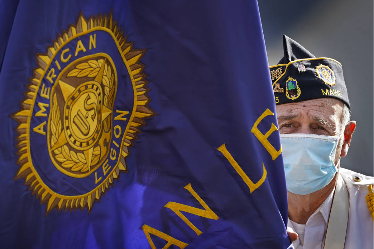 Dick Bell, the post adjutant of the American Legion Post 155, wears a face covering to help pre ...