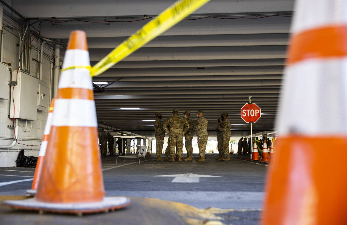 Members of the Nevada National Guard gather during a preview of a drive-thru COVID-19 testing s ...