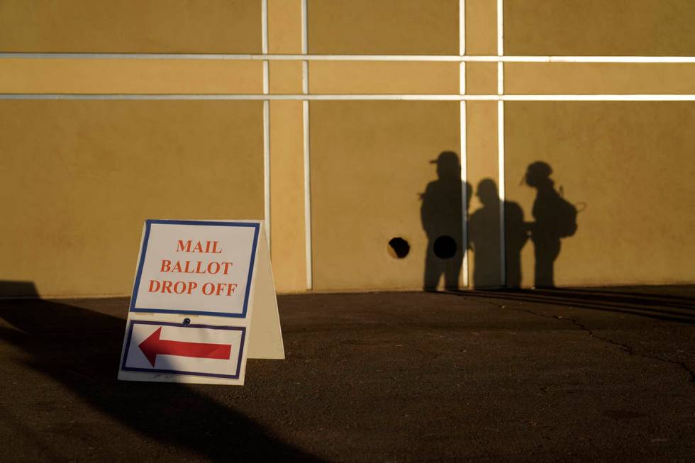 FILE - In this Nov. 3, 2020, file photo people wait outside of a polling place on Election Day ...