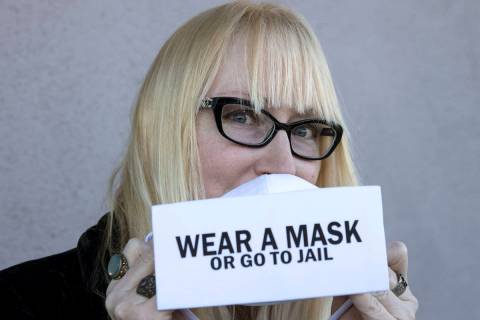 A local fashion designer, Anna Bartoletti, shows off her "Wear a Mask or Go to Jail" ...
