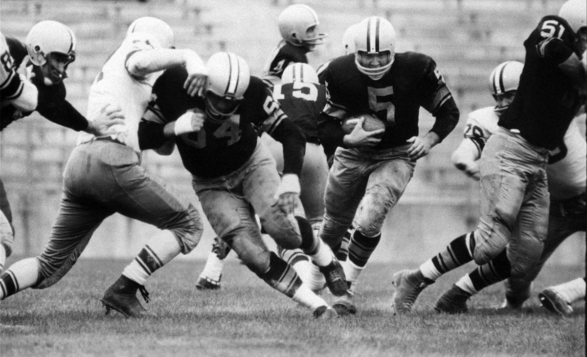 FILE - In this Aug. 10, 1959 file photo, Paul Hornung (5) of the Green Bay Packers goes through ...