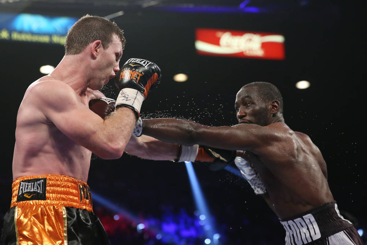 Terence Crawford, right, connects a punch against Jeff Horn in the WBO welterweight World Title ...