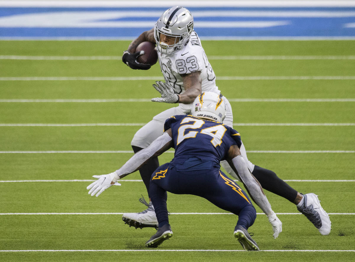 Las Vegas Raiders tight end Darren Waller (83) stiff arms Los Angeles Chargers free safety Nasi ...