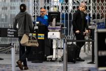 Passengers stop by a Transportation Security Administration checkpoint at McCarran Internationa ...