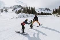 Skiers Chris Benchetler, right, and Kimmy Fasani, left, offering some ski instruction to their ...