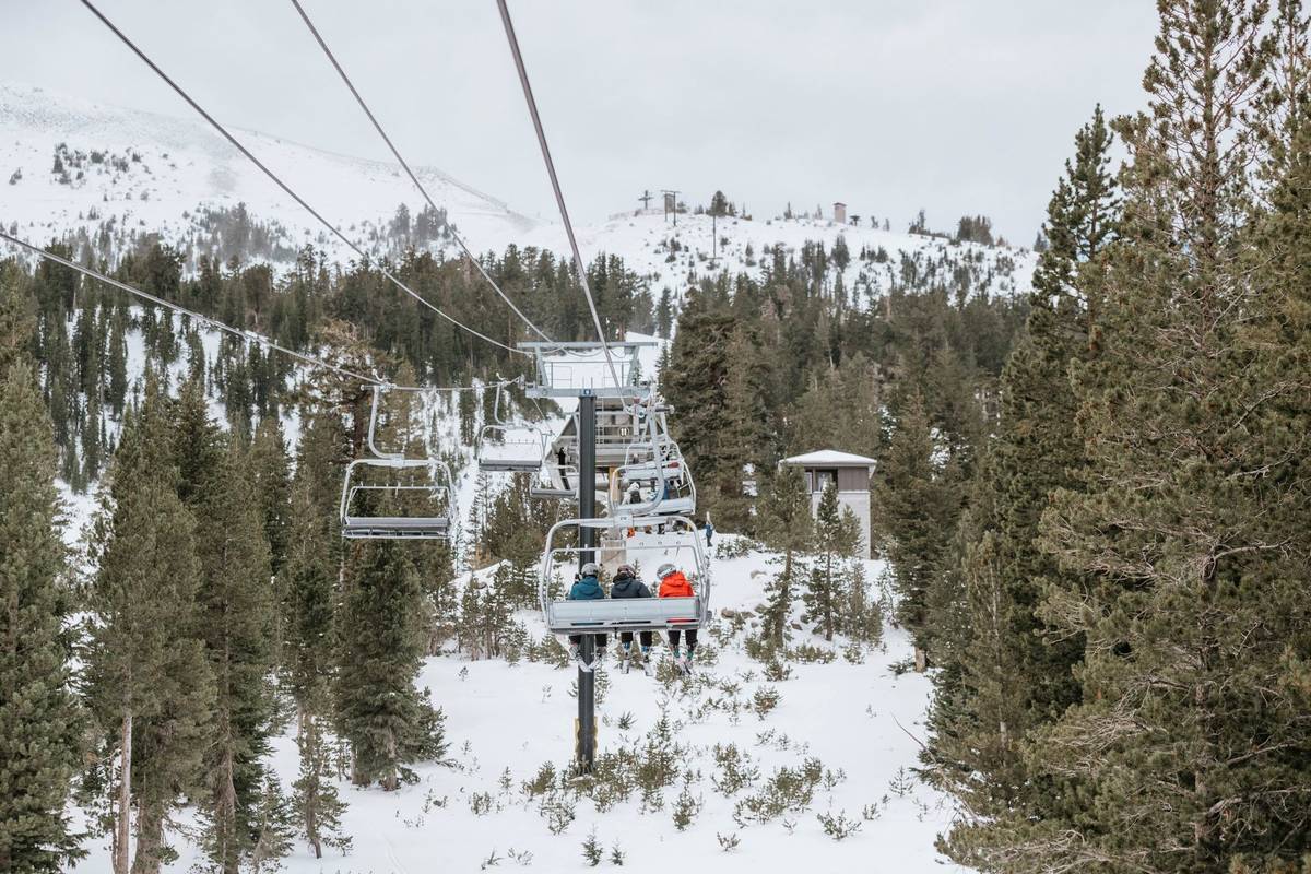 Skiers are seen on a chair lift on opening day of the Mammoth Mountain Ski Area, Calif., Friday ...
