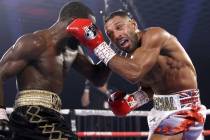 Terence “Bud” Crawford, left, and Kell Brook exchange punches during their title fight Satu ...