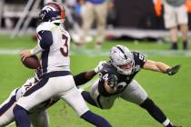 Las Vegas Raiders defensive end Carl Nassib (94) pressures Denver Broncos quarterback Drew Lock ...