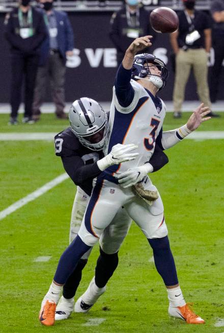 Las Vegas Raiders defensive end Arden Key (99) puts pressure on Denver Broncos quarterback Drew ...