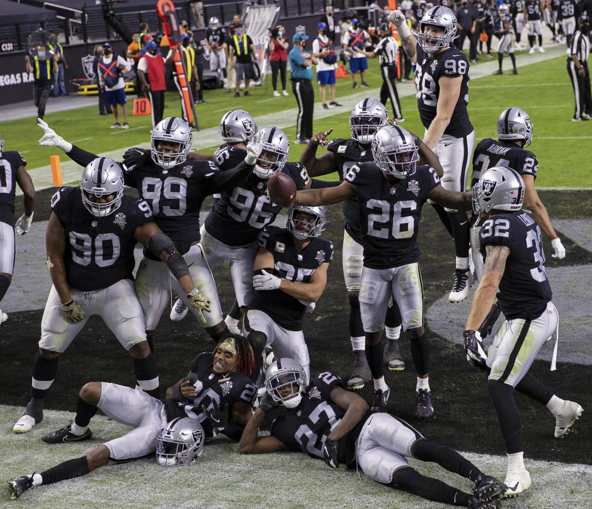 Las Vegas Raiders defensive players celebrate after recovering a fumble in the fourth quarter d ...
