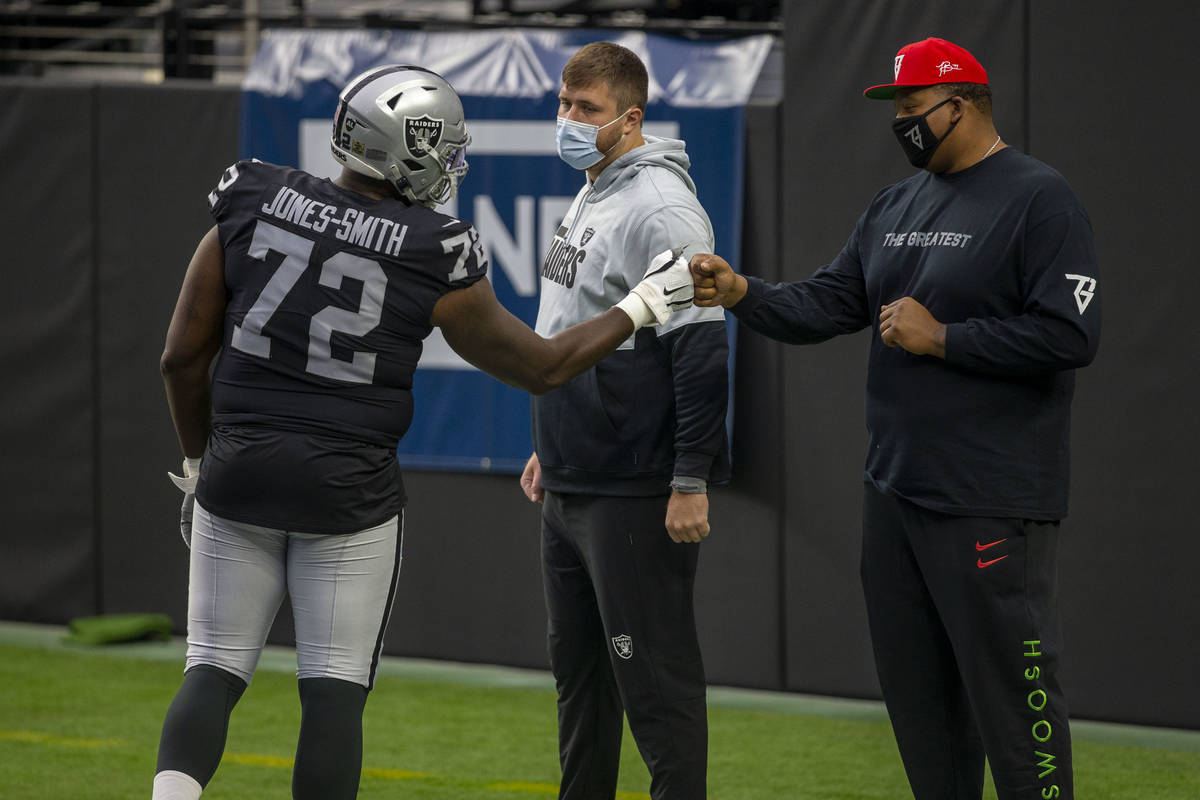 Las Vegas Raiders offensive tackles Kolton Miller, left, and Trent Brown, right, meet with offe ...