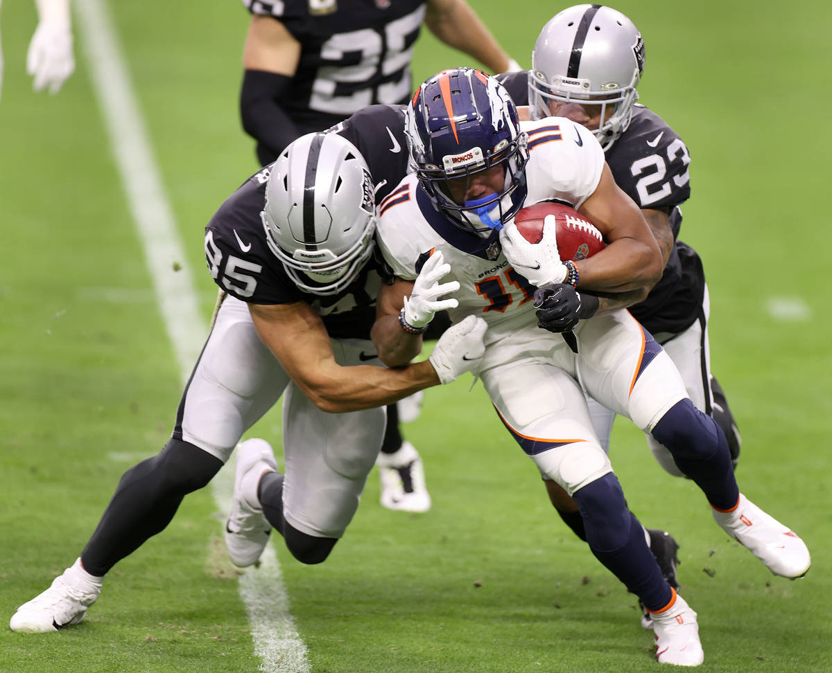 Denver Broncos wide receiver Diontae Spencer (11) is tackled by Las Vegas Raiders tight end Der ...
