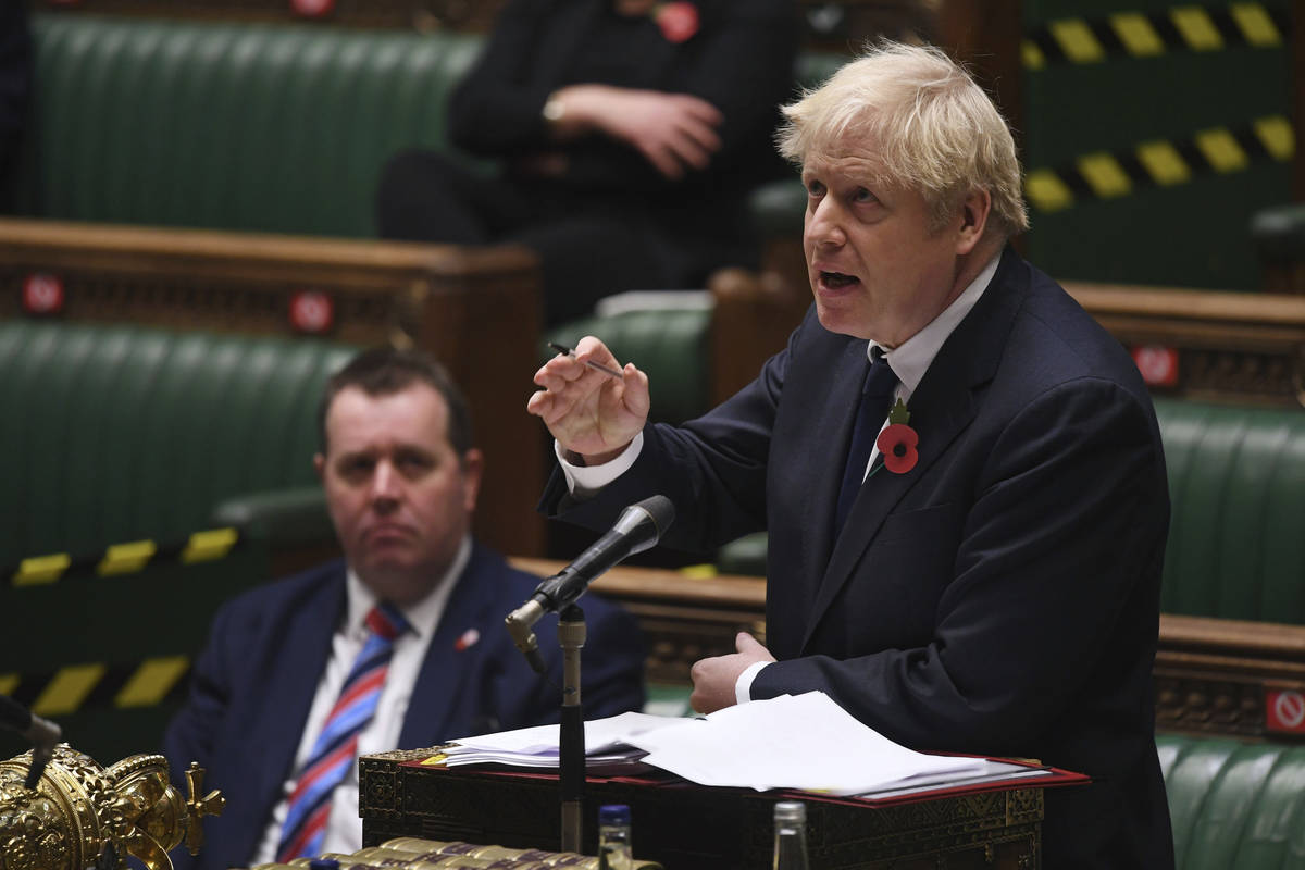 In this handout photo provided by UK Parliament, Britain's Prime Minister Boris Johnson speaks ...