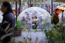Diners sit inside a transparent dome at a restaurant while observing social distancing protocol ...