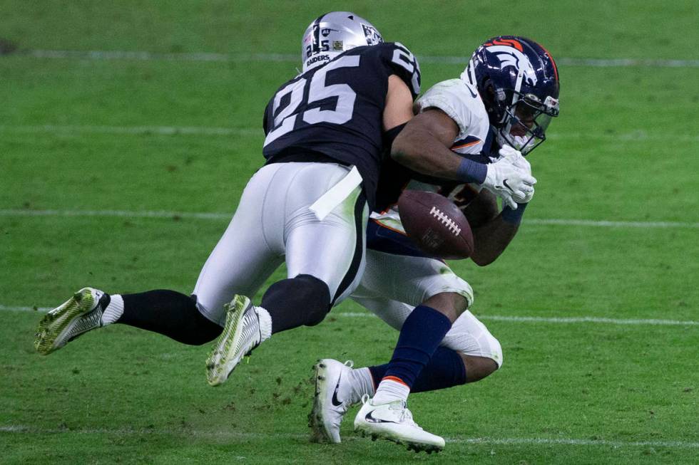 Las Vegas Raiders free safety Erik Harris (25) forces the football out of the hands of Denver B ...