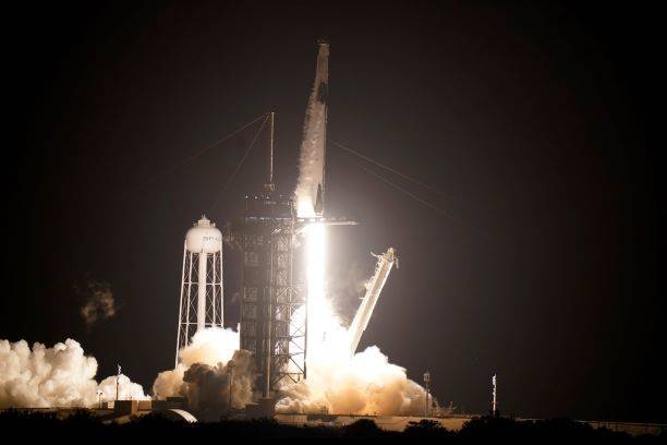 A SpaceX Falcon9 rocket, with the Crew Dragon capsule attached, lift's off from Kennedy Space C ...