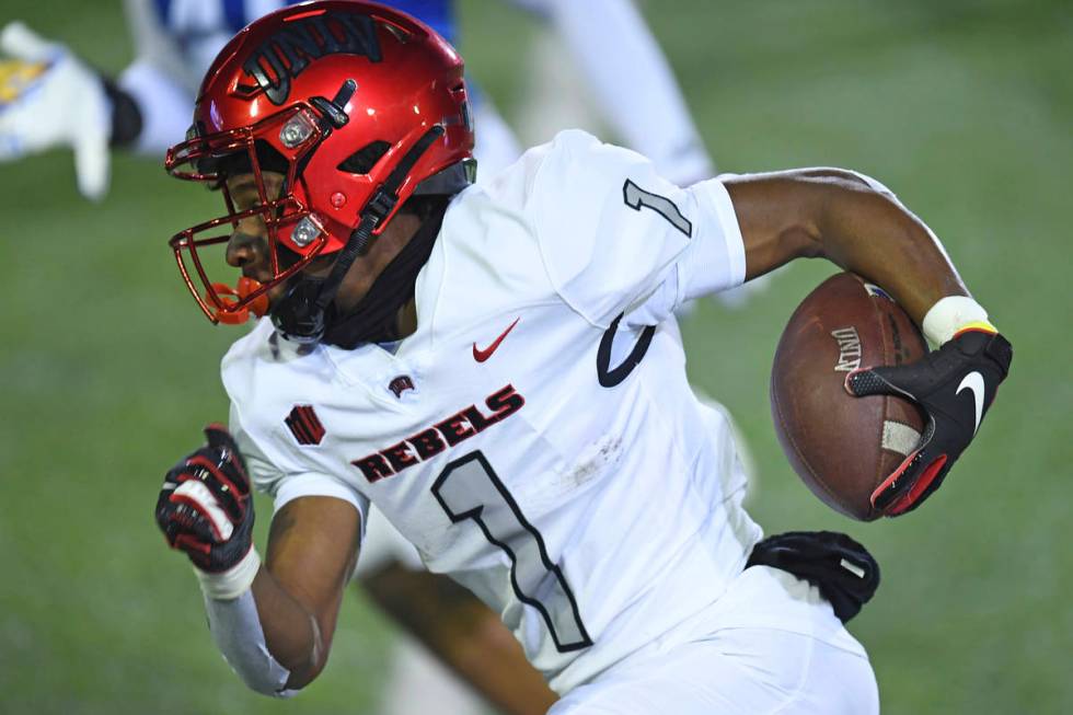 UNLV's Kyle Williams carries against San Jose State during the first quarter of an NCAA college ...