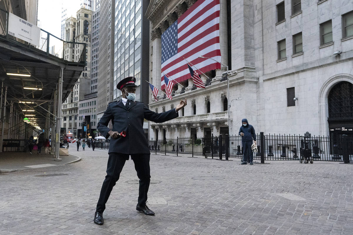 Captain Chaka Watch with the Salvation Army plays air guitar in front of the New York Stock Exc ...