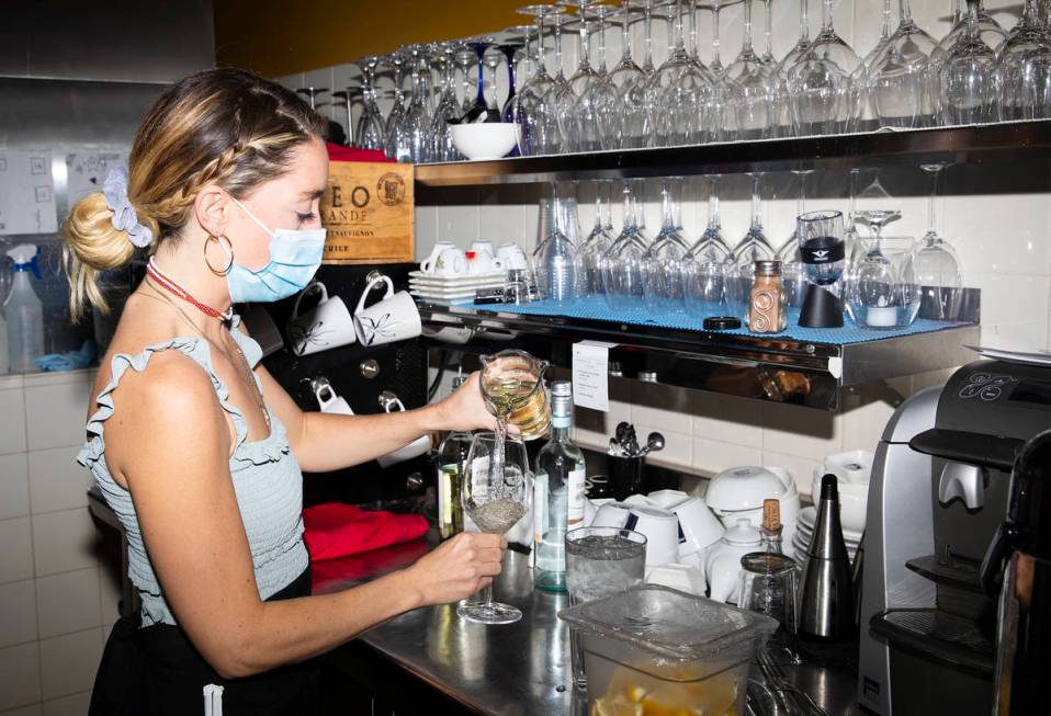 Bianca Alenik pours a glass of wine at Pasta Shop Ristorante in Henderson, Monday, Nov. 16, 202 ...