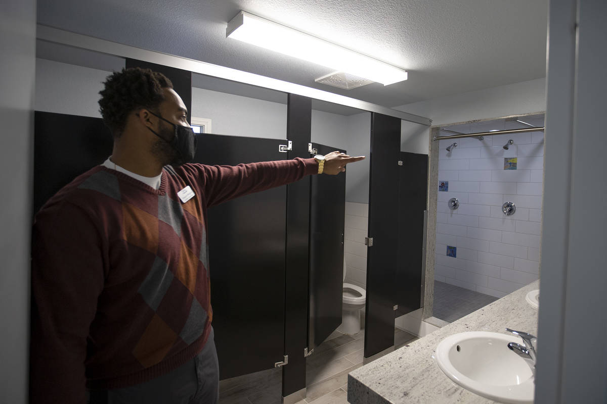 Dwayne Wright II, shelter superviser at Las Vegas Rescue Mission, shows one of the renovated ba ...