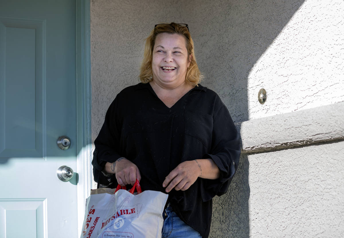 Heaven Burns, 50, of North Las Vegas, receives a holiday inspired New York Strip meal created b ...