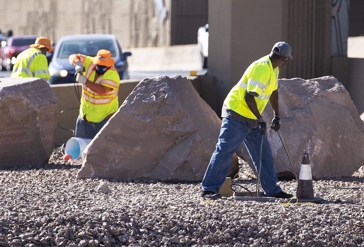 Workers from the Nevada Department of Transportation (NDOT) replace copper wire after Spaghetti ...