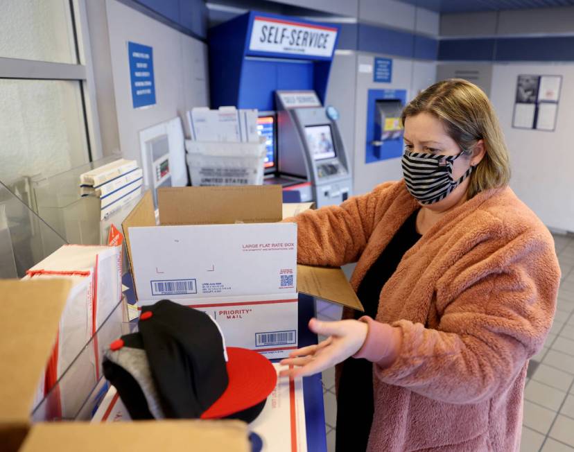 Kim Leddon of Phoenix ships packages at the main Las Vegas Post Office on Sunset Road Wednesday ...