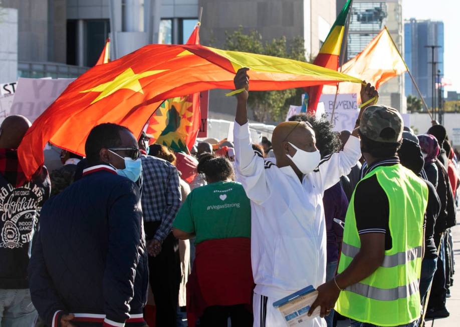 Gebrekidan Desita, center, holds a flag of Tigray outside of the Lloyd D. George Federal Courth ...