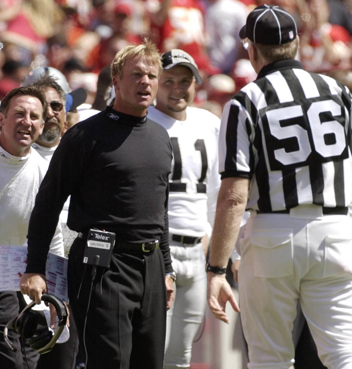 Oakland Raiders coach Jon Gruden, left, asks for an explanation of a call from line judge Ron B ...