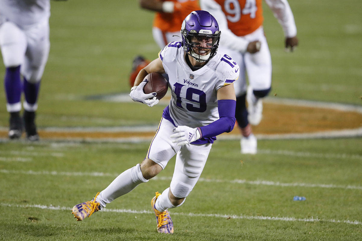 Minnesota Vikings wide receiver Adam Thielen (19) runs with the ball during the first half of a ...