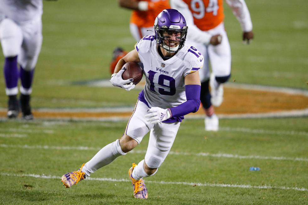 Minnesota Vikings wide receiver Adam Thielen (19) runs with the ball during the first half of a ...