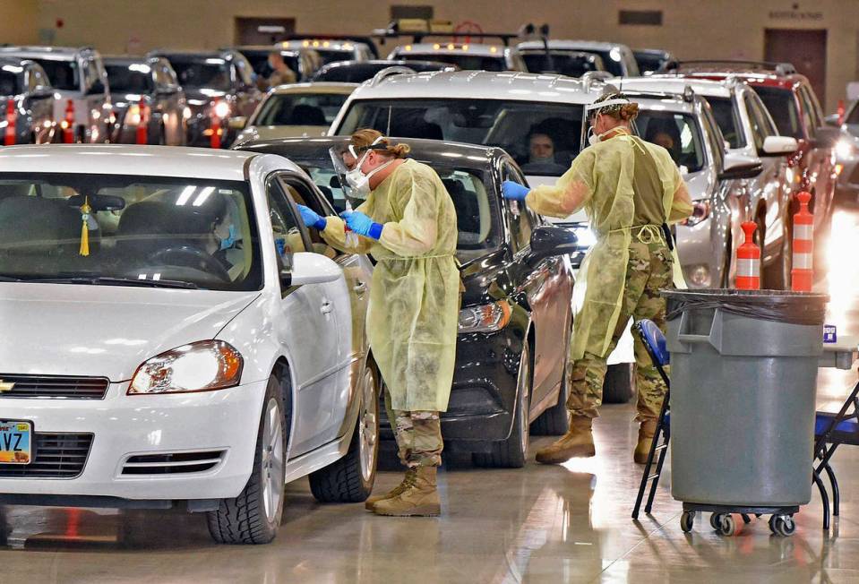 In this Nov. 17, 2020, file photo, North Dakota National Guard soldiers Spc. Samantha Crabbe, l ...