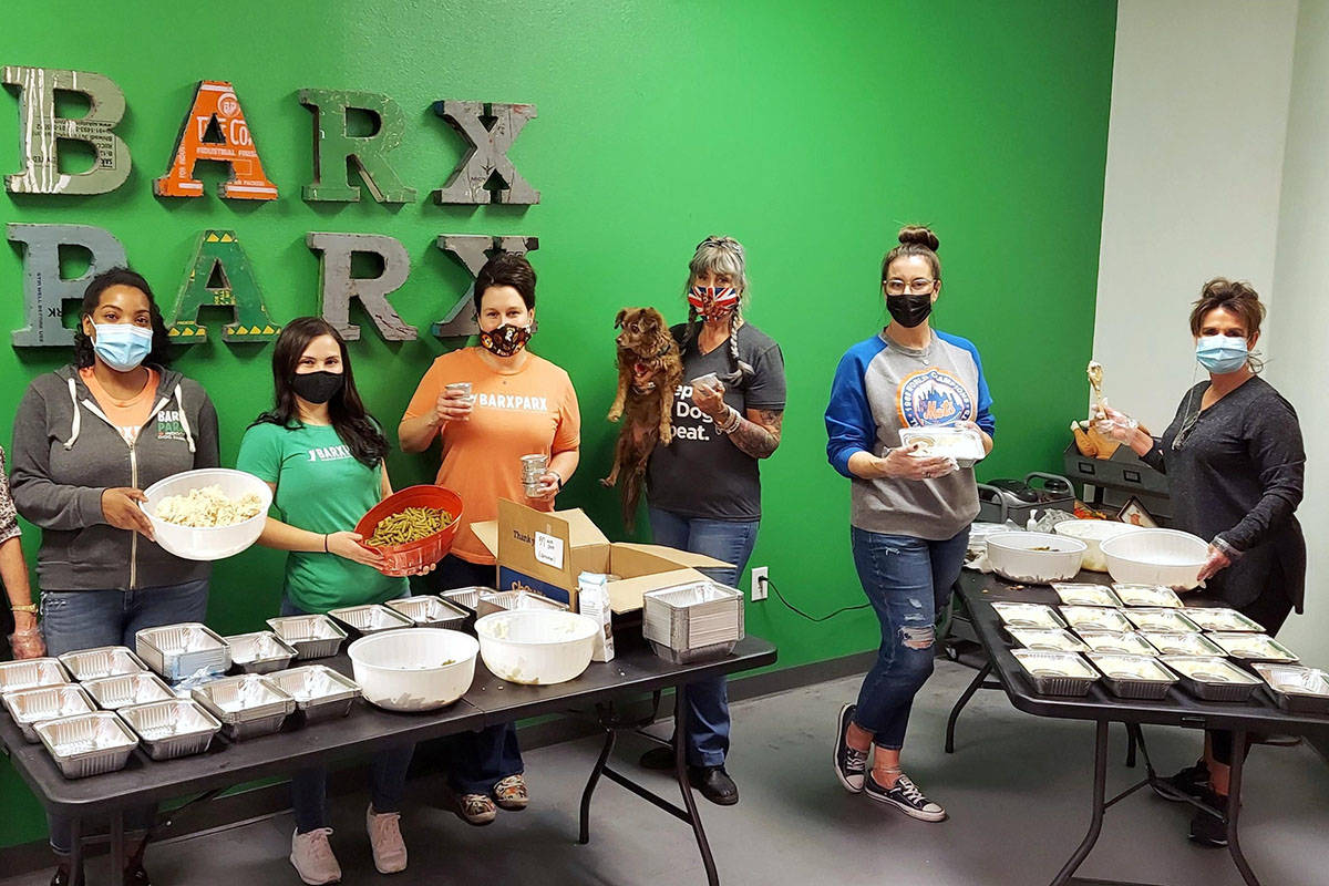 An assembly line of volunteers on Sunday, Nov. 22, 2020, preps "PUPsgiving" meals inside Barx P ...