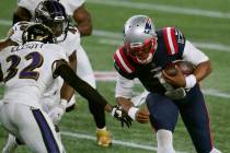 New England Patriots quarterback Cam Newton (1) carries the ball as Baltimore Ravens safety DeS ...