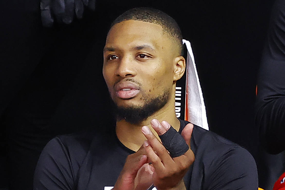 Portland Trail Blazers' Damian Lillard looks on from the sideline after hurting his finger and ...