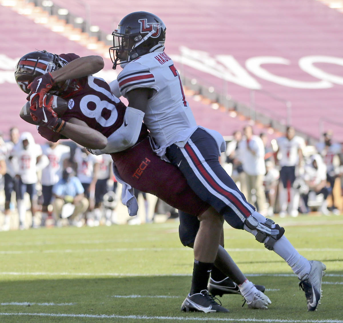 Virginia Tech's Kaleb Smith, left, catches a touchdown pass in front of Liberty's Marcus Haskin ...